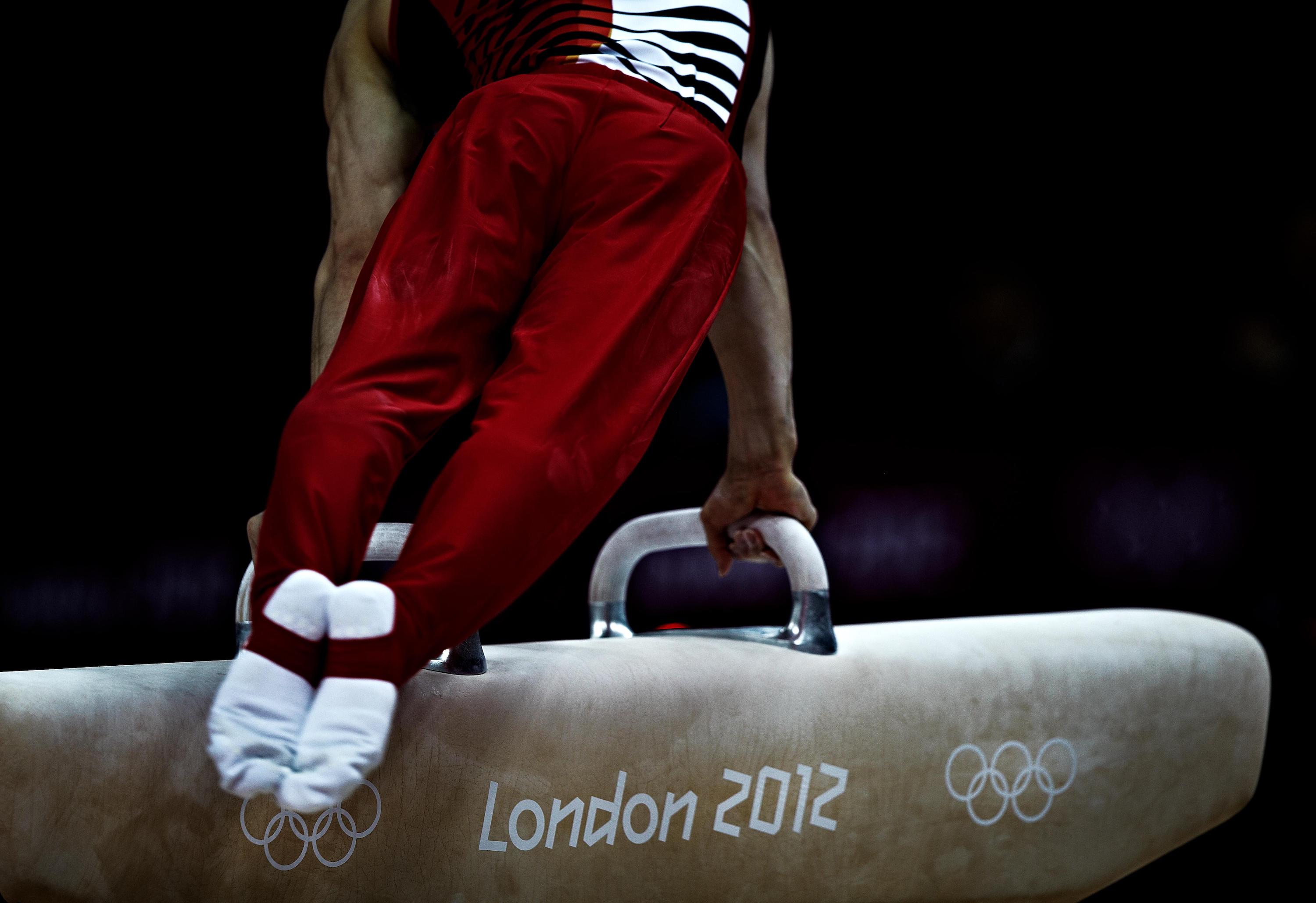 An Olympic gymnast performs a pommel horse routine.