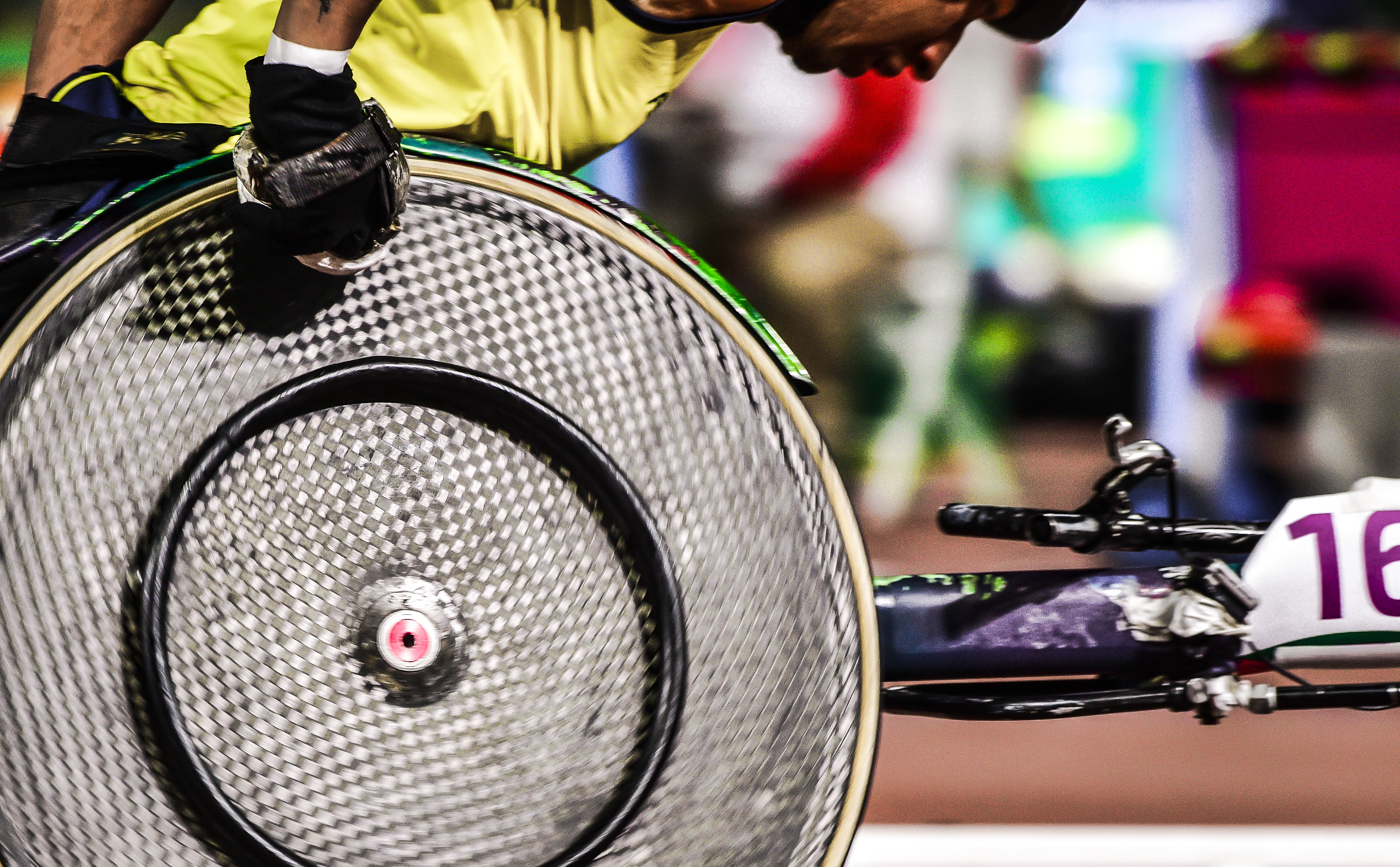 A Paralympic athlete competes in a wheelchair race.